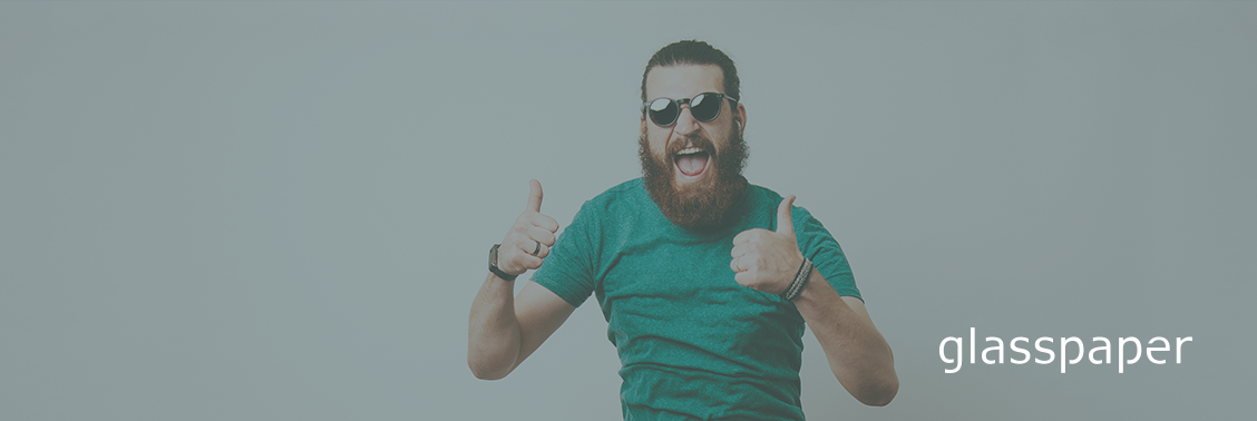 Man with beard and sunglasses doing thumbs up. W hite Glasspaper logo